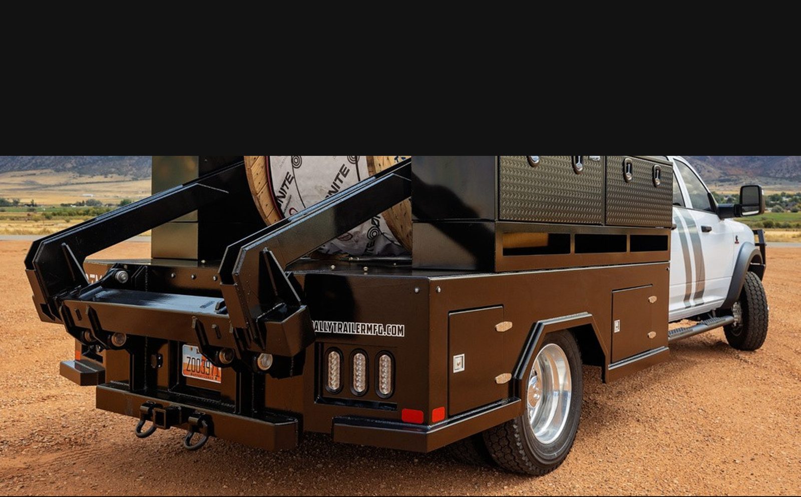 Loaded Rally reel trailer behind a work truck