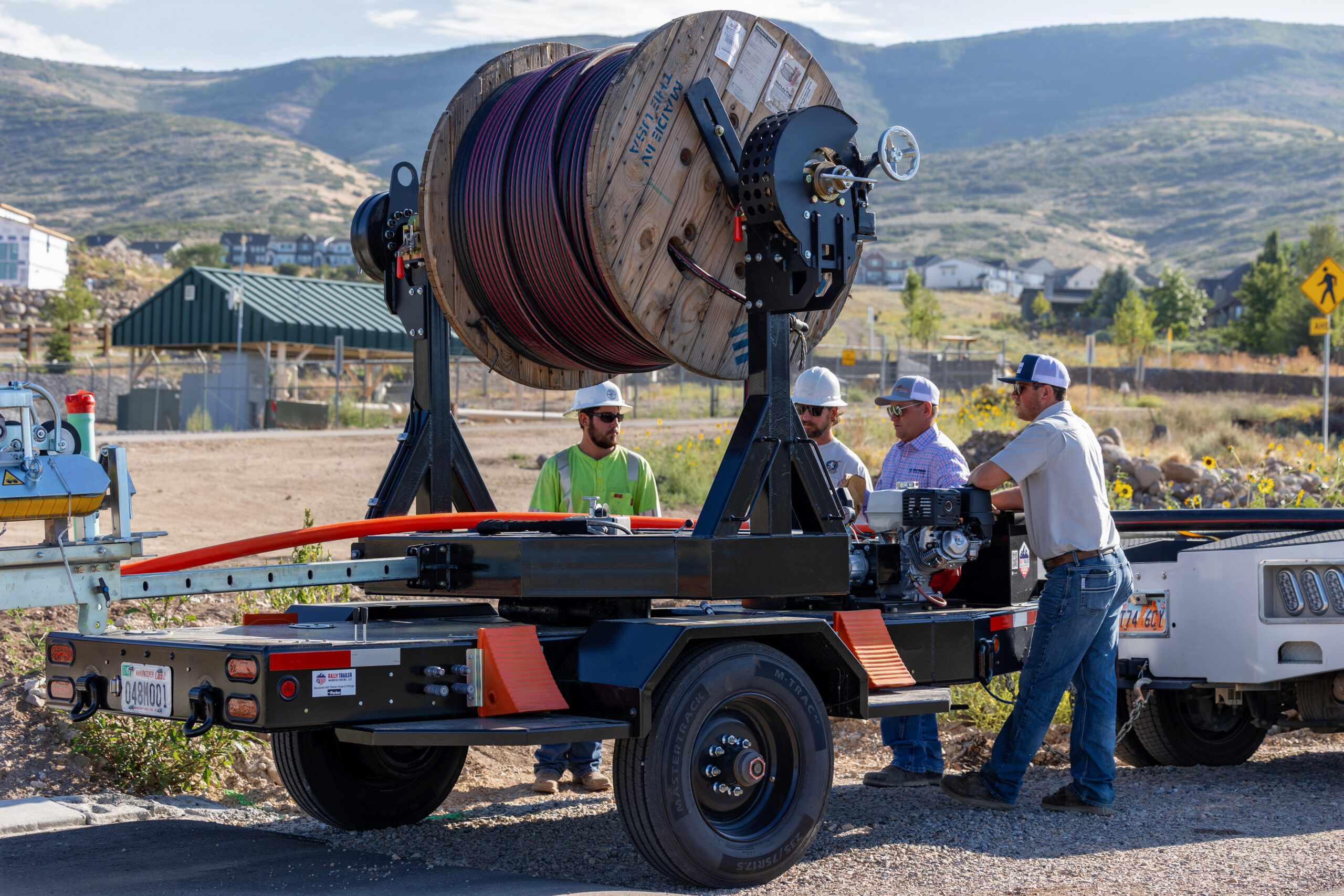 A cable reel trailer manufactured by Rally Trailer being used in the field for the energy industry
